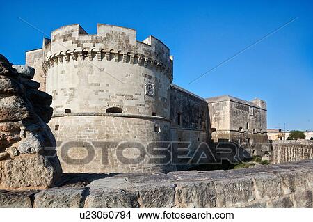 Picture - Typical defense castle of 16th century with rounded stone tower, outer wall and moat, Acaia, sunny spring afternoon, Salento, Puglia, Southern Italy. Fotosearch