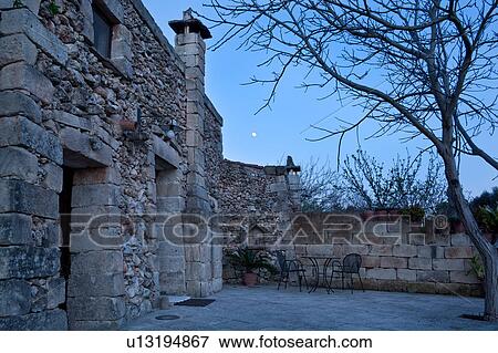 Typical stone farmhouse building, detail from side of entrance and courtyard at twilight with full moon rising, Salento, Puglia, Southern Italy View Large Photo Image Stock Photo - Typical stone farmhouse building, detail from side of entrance and courtyard at twilight with full moon rising, Salento, Puglia, Southern Italy. Fotosearch