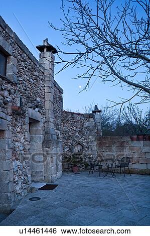 Typical stone farmhouse building, detail from side of entrance and courtyard at twilight with full moon rising, Salento, Puglia, Southern Italy View Large Photo Image Stock Photograph - Typical stone farmhouse building, detail from side of entrance and courtyard at twilight with full moon rising, Salento, Puglia, Southern Italy. Fotosearch