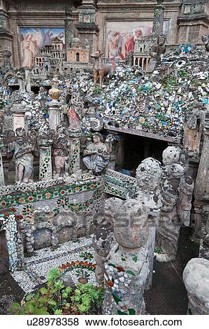 Stock Photo - Unusual stone and ceramic mosaic outdoor crypt with statues and architectural designs against backdrop of frescoed wall, Salento, Puglia, Southern Italy. Fotosearch