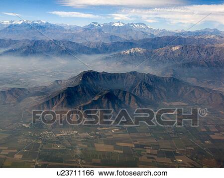 Stock Photograph - View of Cordillera range of mountains and fields as seen from aeroplane, Santiago, Chile. Fotosearch