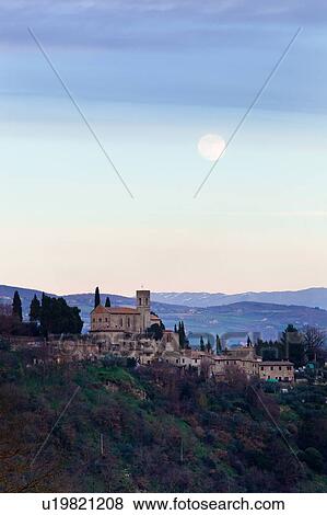 View of hilltop town of Monte Mulino, near Todi, with deserted castle in foreground, with distant hills and pink skyscape, full moon rising, Umbria, Italy View Large Photo Image Stock Photo - View of hilltop town of Monte Mulino, near Todi, with deserted castle in foreground, with distant hills and pink skyscape, full moon rising, Umbria, Italy. Fotosearch
