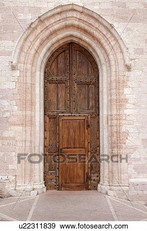 View of old double wooden arched door, with central rectangular entrance, of Santa Chiara church, with patterned pavimenti entrance, Assisi, Umbria, Italy View Large Photo Image Stock Photo - View of old double wooden arched door, with central rectangular entrance, of Santa Chiara church, with patterned pavimenti entrance, Assisi, Umbria, Italy. Fotosearch