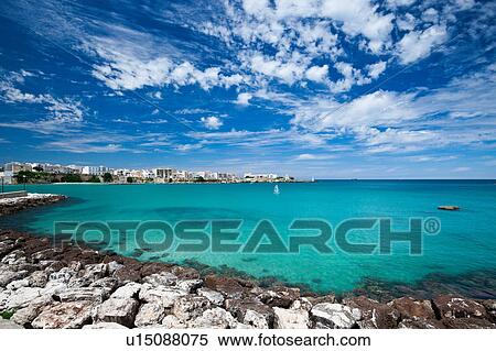 View of Otranto harbour with clear green water, moored sailboats and motorboats, town beyond, sunny spring morning with dramatic clouds in blue sky, Salento, Puglia, Southern Italy View Large Photo Image Stock Photography - View of Otranto harbour with clear green water, moored sailboats and motorboats, town beyond, sunny spring morning with dramatic clouds in blue sky, Salento, Puglia, Southern Italy. Fotosearch