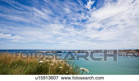 View of Otranto harbour with moored sailboats, cargo boat, and motorboats, sunny spring morning with dramatic clouds in blue sky, Salento, Puglia, Southern Italy View Large Photo Image Stock Photo - View of Otranto harbour with moored sailboats, cargo boat, and motorboats, sunny spring morning with dramatic clouds in blue sky, Salento, Puglia, Southern Italy. Fotosearch