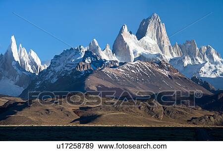 View of sunrise over the snow covered Andes mountain range, El Chalten, Argentina, Patagonia, with clear blue sky, over Mount Fitzroy and Cerro Torre View Large Photo Image Stock Photo - View of sunrise over the snow covered Andes mountain range, El Chalten, Argentina, Patagonia, with clear blue sky, over Mount Fitzroy and Cerro Torre. Fotosearch