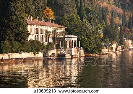 View overlooking Lake Como and mountain slope with Villa Monastero on sunny autumn afternoon, Lake Como, Northern Italy View Large Photo Image Stock Image - View overlooking Lake Como and mountain slope with Villa Monastero on sunny autumn afternoon, Lake Como, Northern Italy. Fotosearch