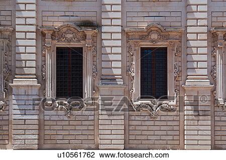 Window detail: ornate Baroque facade of Palazzo del Seminario, ornately carved in Leccese style, grid of metal bars across 2 windows, Lecce, Salento, Puglia, Southern Italy View Large Photo Image Stock Image - Window detail: ornate Baroque facade of Palazzo del Seminario, ornately carved in Leccese style, grid of metal bars across 2 windows, Lecce, Salento, Puglia, Southern Italy. Fotosearch