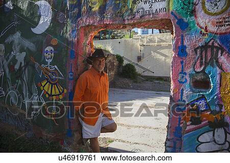 Stock Image - Bisbee, Arizona, USA, April 6, 2015, Chuck Tampio in Orange Shirt. Fotosearch