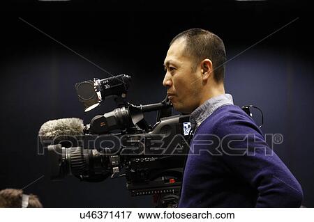 Stock Photo - LAS VEGAS NEVADA, DECEMBER 14, 2015: Asian cameraman awaits Presidential Rally by Donald Trump at the Westgate Las Vegas Resort & Casino the day before the CNN Republican LAS VEGAS NEVADA, DECEMBER 14, 2015: Asian cameraman awaits Presidential Rally.... Fotosearch