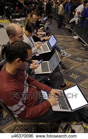 Stock Photograph - LAS VEGAS NEVADA, DECEMBER 14, 2015: national news media tpes into computers during Trump Presidential campaign event at Westgate Las Vegas Resort & Casino the day before the CNN Republican Presidential Debate. Fotosearch