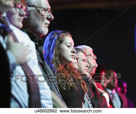 Stock Image - LAS VEGAS, NV - OCTOBER 13 2015: (L-R) Democratic presidential debate shows audience during opening pledge of allegiance.. Fotosearch