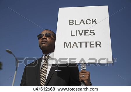 Stock Photo - Los Angeles, California, USA, January 19, 2015, 30th annual Martin Luther King Jr. Kingdom Day Parade, black man hold sign "Black Lives Matter". Fotosearch