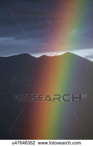 Stock Image - Oak View, California, USA, March 1, 2015, full rainbow over rain storm in Ojai Valley. Fotosearch