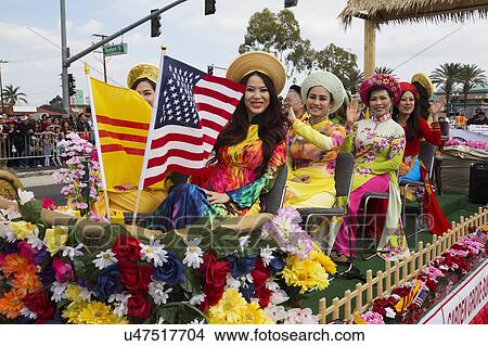 Orange County, City of Westminster, Southern California, USA, February 21, 2015, Little Saigon, Vietnamese-American Community, TET Parade celebrates Tet Lunar New Year, women on float with US Flag View Large Photo Image Picture - Orange County, City of Westminster, Southern California, USA, February 21, 2015, Little Saigon, Vietnamese-American Community, TET Parade celebrates Tet Lunar New Year, women on float with US Flag. Fotosearch