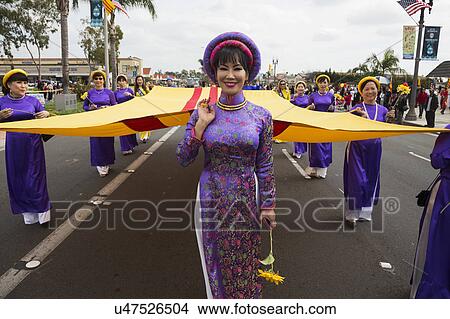 Picture - Orange County, City of Westminster, Southern California, USA, February 21, 2015, Little Saigon, Vietnamese-American Community, TET Parade celebrates Tet Lunar New Year, women march in parade with S Vietnamese flag. Fotosearch