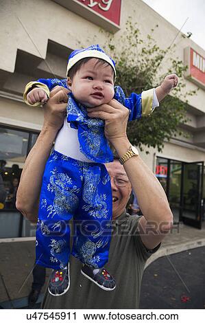 Stock Image - Orange County, City of Westminster, Southern California, USA, February 21, 2015, Little Saigon, Vietnamese-American Community, TET Parade celebrates Tet Lunar New Year, little baby. Fotosearch