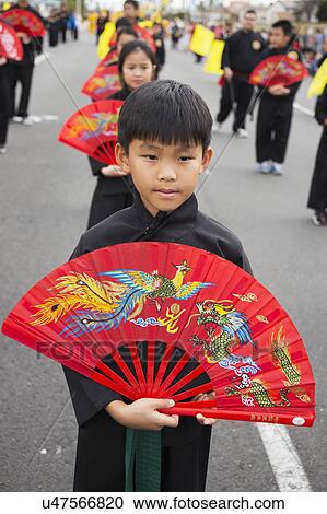 Stock Image - Orange County, City of Westminster, Southern California, USA, February 21, 2015, Little Saigon, Vietnamese-American Community, TET Parade celebrates Tet Lunar New Year, you boy with decorative fan. Fotosearch