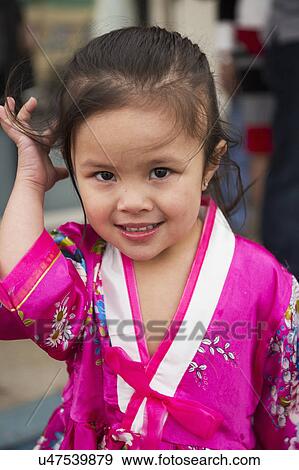Orange County, City of Westminster, Southern California, USA, February 21, 2015, Little Saigon, Vietnamese-American Community, TET Parade celebrates Tet Lunar New Year, young girl smiles View Large Photo Image Stock Photo - Orange County, City of Westminster, Southern California, USA, February 21, 2015, Little Saigon, Vietnamese-American Community, TET Parade celebrates Tet Lunar New Year, young girl smiles. Fotosearch