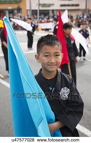 Stock Photo - Orange County, City of Westminster, Southern California, USA, February 21, 2015, Little Saigon, Vietnamese-American Community, TET Parade celebrates Tet Lunar New Year, young boy with flag. Fotosearch