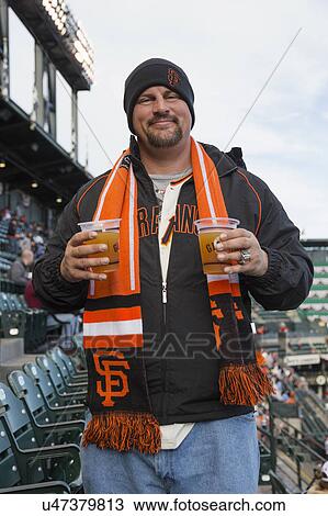 Stock Image - San Francisco, California, USA, October 16, 2014, AT&T Park, baseball stadium, SF Giants versus St. Louis Cardinals, National League Championship Series (NLCS), fan with beer. Fotosearch