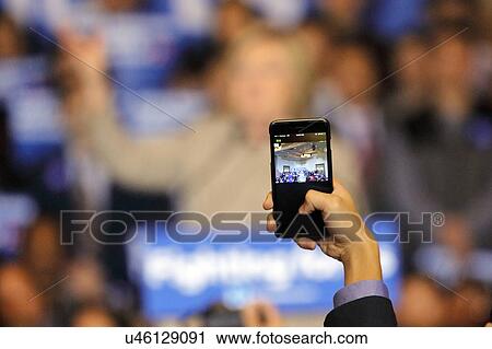 Stock Image - SAN GABRIEL, LA, CA - JANUARY 7, 2016, through a smart phone, we see on the screen Democratic Presidential candidate Hillary Clinton speaking to Asian American and Pacific Islander (AAPI) members. Fotosearch