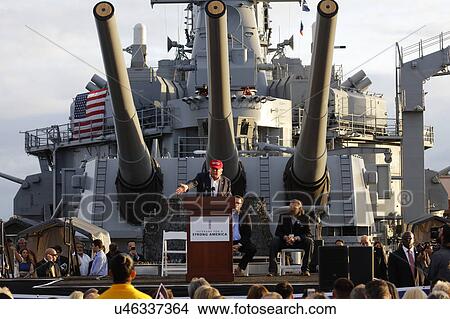 SAN PEDRO, CA - SEPTEMBER 15, 2015: Donald Trump, 2016 Republican presidential candidate, speaks under large battleship guns during a rally aboard the Battleship USS Iowa in San Pedro, Los Angeles, California. View Large Photo Image Picture - SAN PEDRO, CA - SEPTEMBER 15, 2015: Donald Trump, 2016 Republican presidential candidate, speaks under large battleship guns during a rally aboard the Battleship USS Iowa in San Pedro, Los Angeles, California.. Fotosearch