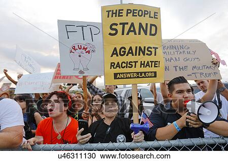 Stock Image - SAN PEDRO, CA - SEPTEMBER 15, 2015: Hispanic protestors at Donald Trump 2016 Republican presidential rally aboard the Battleship USS Iowa in San Pedro, Los Angeles, California.. Fotosearch