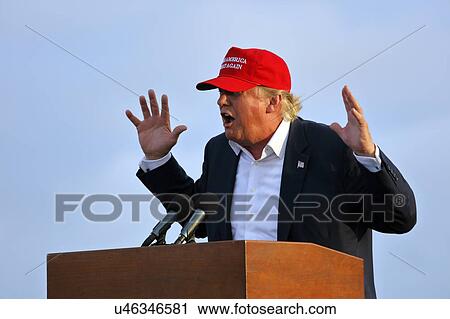 Stock Image - SAN PEDRO, CA - SEPTEMBER 15, 2015: Donald Trump, 2016 Republican presidential candidate, speaks during a rally aboard the Battleship USS Iowa in San Pedro, Los Angeles, California while wearing a red baseball hat that says campaign slogan "Make.... Fotosearch
