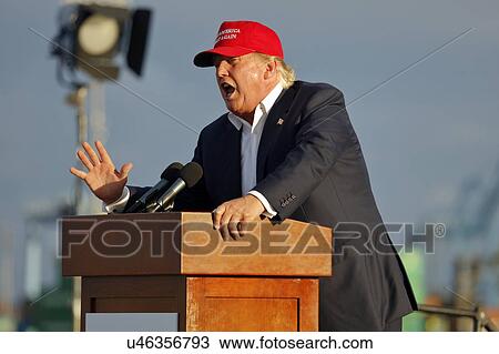 Stock Image - SAN PEDRO, CA - SEPTEMBER 15, 2015: Donald Trump, 2016 Republican presidential candidate, speaks during a rally aboard the Battleship USS Iowa in San Pedro, Los Angeles, California while wearing a red baseball hat that says campaign slogan "Make.... Fotosearch