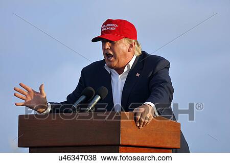 Stock Photo - SAN PEDRO, CA - SEPTEMBER 15, 2015: Donald Trump, 2016 Republican presidential candidate, speaks during a rally aboard the Battleship USS Iowa in San Pedro, Los Angeles, California while wearing a red baseball hat that says campaign slogan "Make.... Fotosearch