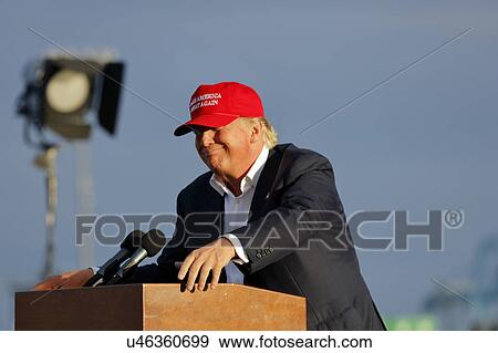 Stock Photo - SAN PEDRO, CA - SEPTEMBER 15, 2015: Donald Trump, 2016 Republican presidential candidate, speaks during a rally aboard the Battleship USS Iowa in San Pedro, Los Angeles, California while wearing a red baseball hat that says campaign slogan "Make.... Fotosearch
