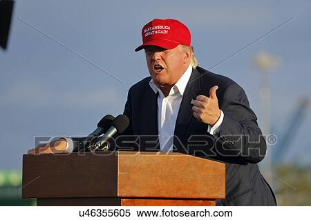 Stock Photography - SAN PEDRO, CA - SEPTEMBER 15, 2015: Donald Trump, 2016 Republican presidential candidate, speaks during a rally aboard the Battleship USS Iowa in San Pedro, Los Angeles, California while wearing a red baseball hat that says campaign slogan "Make.... Fotosearch