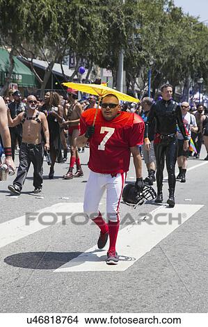 West Hollywood, Los Angeles, California, USA, June 14, 2015, 40th annual Gay Pride Parade for LGBT Community, down Santa Monica Blvd., football player with #7 jersey and yellow umbrella View Large Photo Image Picture - West Hollywood, Los Angeles, California, USA, June 14, 2015, 40th annual Gay Pride Parade for LGBT Community, down Santa Monica Blvd., football player with #7 jersey and yellow umbrella. Fotosearch