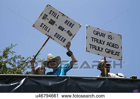 Stock Image - West Hollywood, Los Angeles, California, USA, June 14, 2015, 40th annual Gay Pride Parade for LGBT Community, down Santa Monica Blvd., signs saying "still here still queer" - gay grays, Senior Citizens. Fotosearch