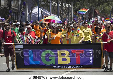 Stock Image - West Hollywood, Los Angeles, California, USA, June 14, 2015, 40th annual Gay Pride Parade for LGBT Community, down Santa Monica Blvd., LGBT Public Library Banner and marchers. Fotosearch