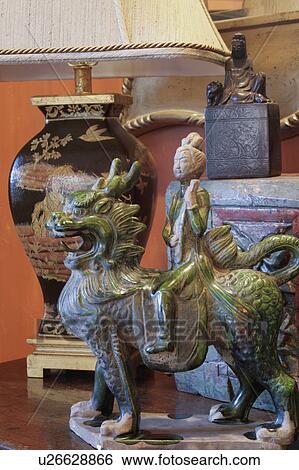 Stock Photograph - Asian statue on end table. Fotosearch
