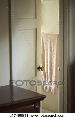 Stock Image - Bathroom door open to reveal a towel. Fotosearch