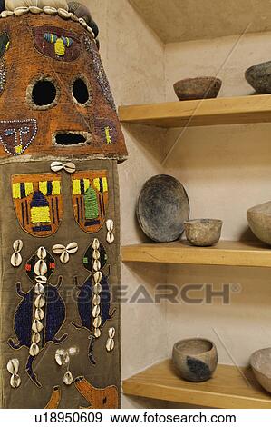 Stock Photo - Beaded African mask and Native American pottery. Fotosearch