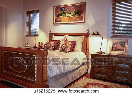 Stock Photography - Bed in traditional bedroom. Fotosearch