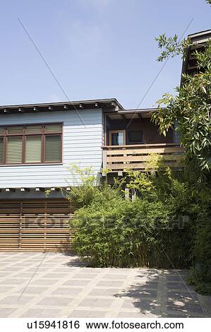 Stock Photograph - Blue sided house with wooden accents. Fotosearch