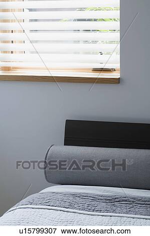 Stock Photo - Bolster pillow on bed. Fotosearch