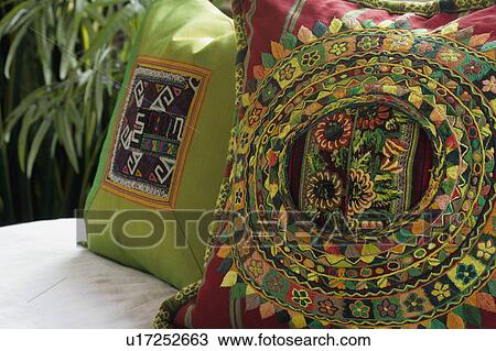 Stock Image - Close up of colorful decorative throw pillows. Fotosearch
