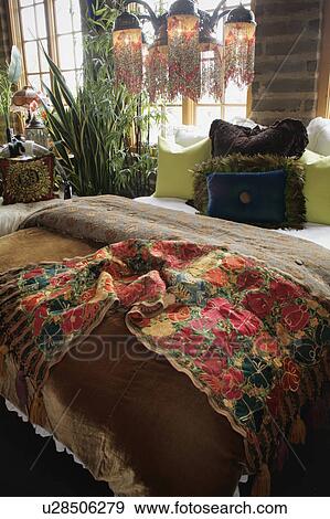 Stock Photo - Colorful bed runner and throw pillows on bed. Fotosearch