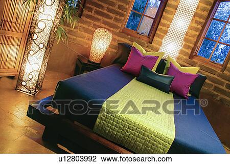 Stock Image - Colorful bedding on bed. Fotosearch