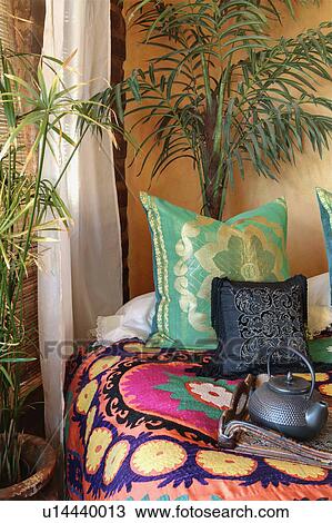Stock Image - Colorful throw pillows on bed. Fotosearch
