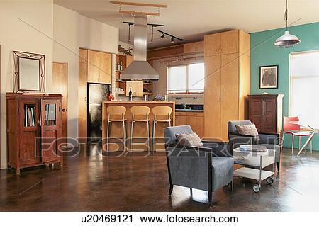Stock Image - Contemporary kitchen and living room in loft apartment. Fotosearch