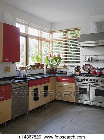 Contemporary kitchen with red cabinets View Large Photo Image Stock Image - Contemporary kitchen with red cabinets. Fotosearch