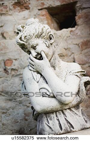 Stock Photography - Coy girl stone statue detail. Fotosearch