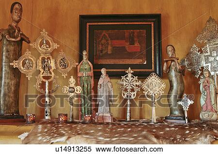 Stock Photography - Decorative figurines and crosses on mantle. Fotosearch